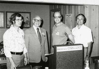 Four men at a Rancho de las Caballeros podium