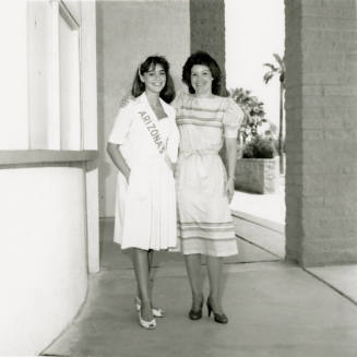 Two unidentified women standing in a breezeway