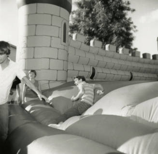 Unidentified children on inflated mock castle