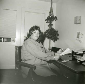 Unidentified woman sitting at an office desk
