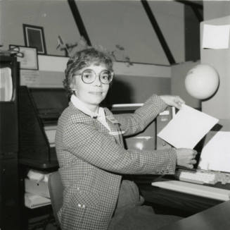 Woman sitting at her desk. November 1984