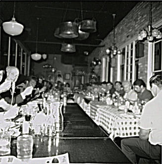 Unknown group of people dining in a large room