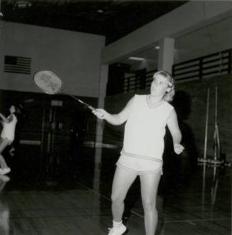 Unidentified Woman Practicing With Racket in Gym - (1 of 3)