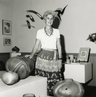 Unidentified Woman Standing Amid Pottery & Pots