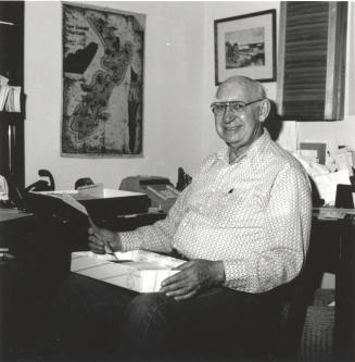 Unidentified Man seated at Desk