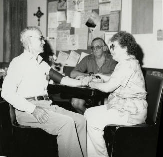Three unidentified people sitting at a table