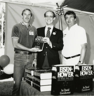 David Eisenhower and two men at a book signing, Sister City Oktoberfest