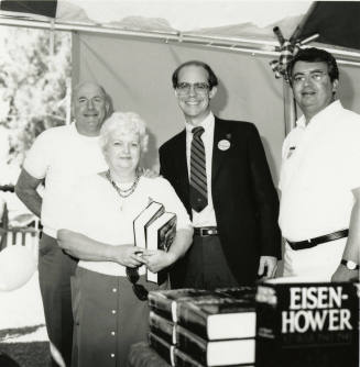 David Eisenhower and two men and a woman at a book signing, Sister City Oktoberfest