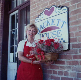 Jane Neuheisel holds flowers at the Hackett House