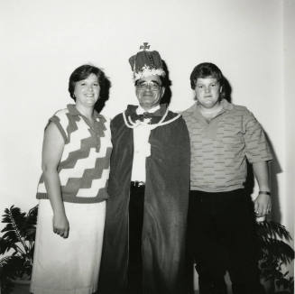 Man dressed as king with two other people