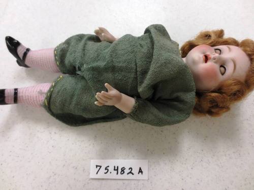 Doll in green jump suit