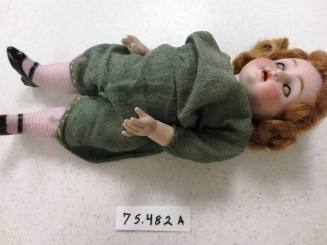 Doll in green jump suit
