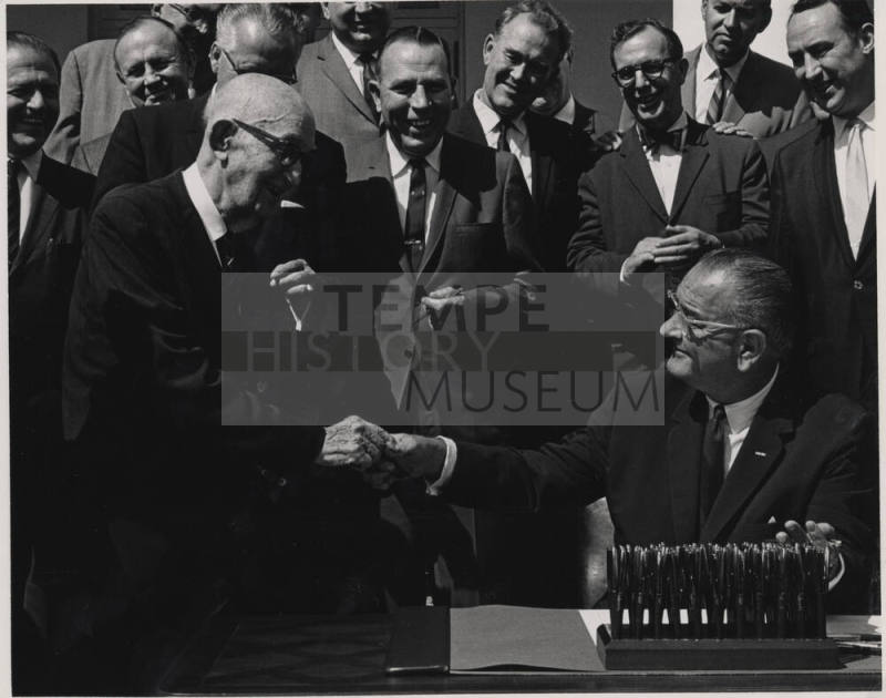 Carl Hayden Shakes Hand of seated L. B. Johnson Signing a Bill