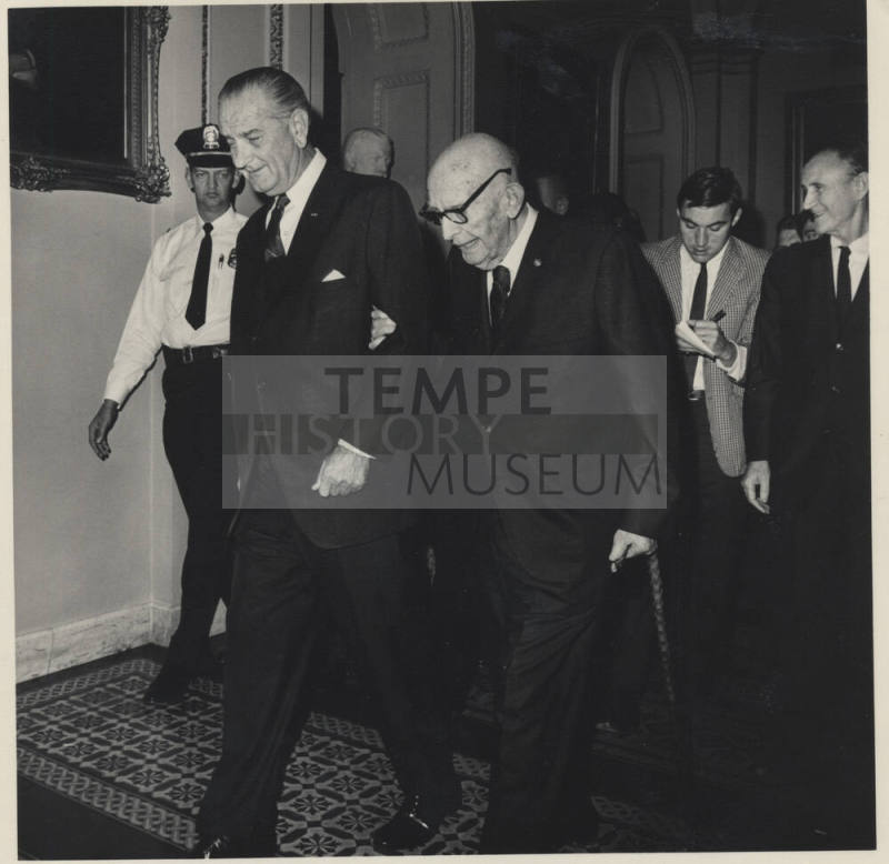Senator Hayden on L. B. Johnson's Arm, with Cane in Hallway leading a Group