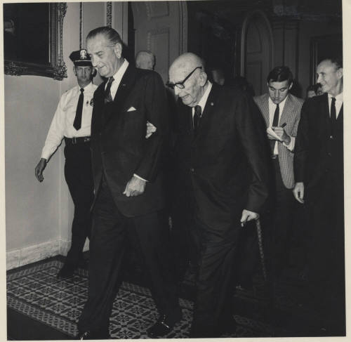 Senator Hayden on L. B. Johnson's Arm, with Cane in Hallway leading a Group