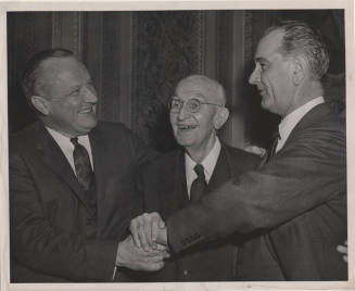 Senator Hayden, Lyndon B. Johnson and Senator William F. Knowland clasp hands together.