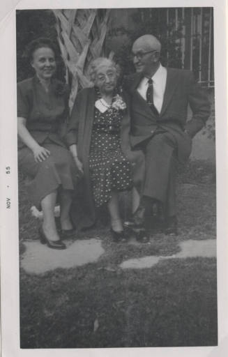 Dolly, Nan, and Carl Hayden seated on a Bench by a Palm Tree