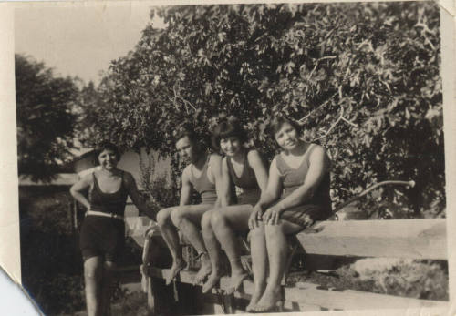 Four people in swimming suits.