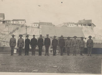 Men in the National Guard standing in a mining town
