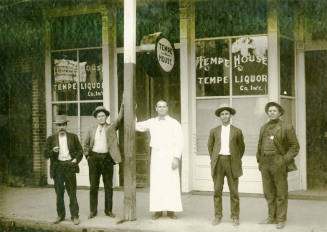 Men standing in front of Tempe House Liquor store