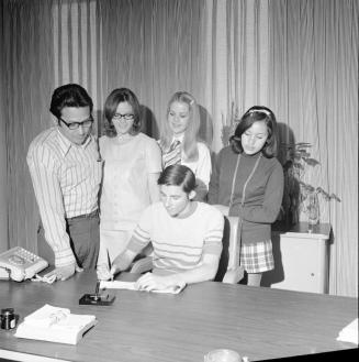5 people at signing of document