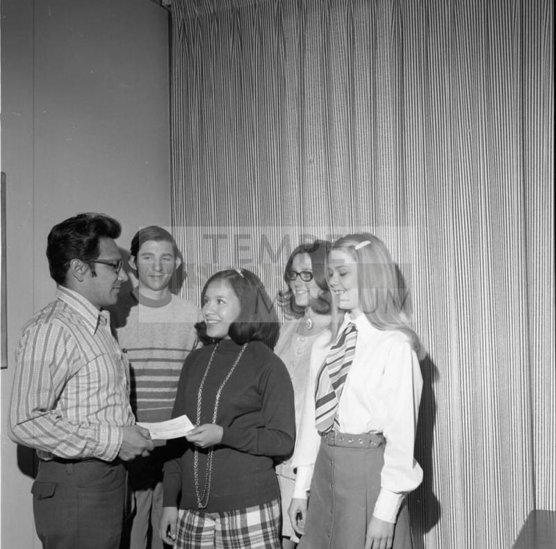 Five people standing at presentation
