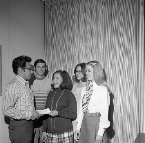 Five people standing at presentation