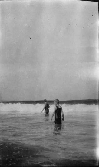 Image of a 2 boys wading into the ocean