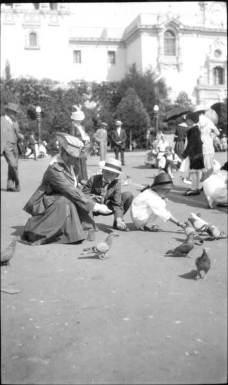 Ruby, Charles Howard, and Dorothy feeding pigeons
