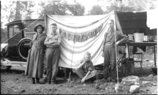 Ruby, Charles Harold, and Dorothy, and young man at campsite chuckwagon