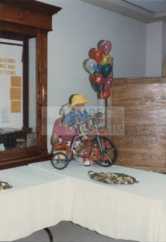 Photograph - Child's Tricycle with a Teddy Bear Decoration at Reception
