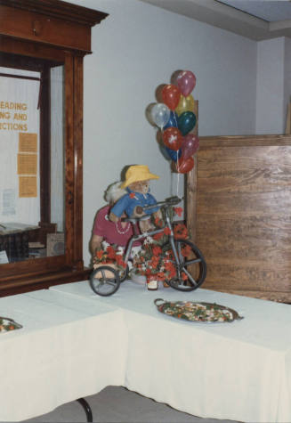 Photograph - Child's Tricycle with a Teddy Bear Decoration at Reception