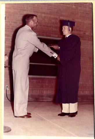 Photograph of Robert Royse Receiving Diploma from Mr. Owens
