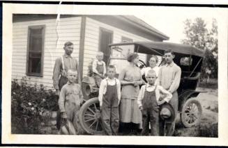 Family Photograph infront of their house and model A car