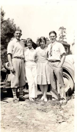 Photo of Raymond couples in front of a model a car