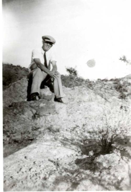 Frank Raymond Sitting on Rocks in the Desert