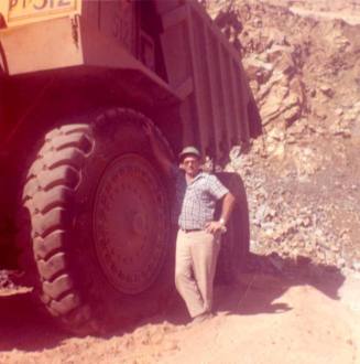 Jim Raymond Stands Next to a Large Vehicle