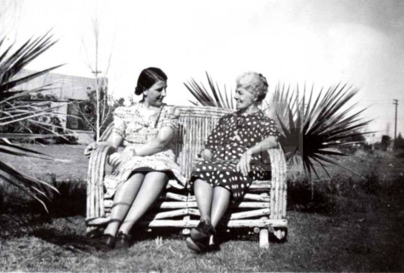 Minnie (Laird) Raymond and Nell (Cummins) Laird Sit on a Bamboo Bench