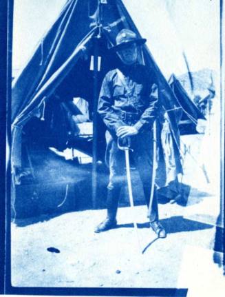 Frank Raymond in Uniform Standing Near a Tent