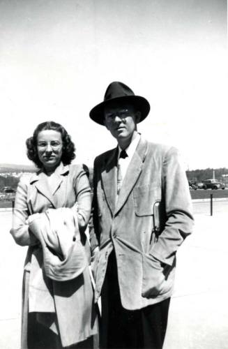 William Raymond Poses with a Woman for a Photo