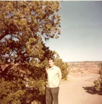 Bill Raymond Poses Outdoors Near a Tree