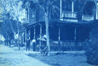 Petersen house with family standing at corner