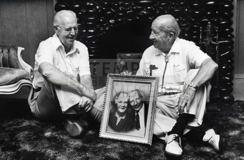 Photo of the Carr Brothers in a Carr Home with their parent’s picture