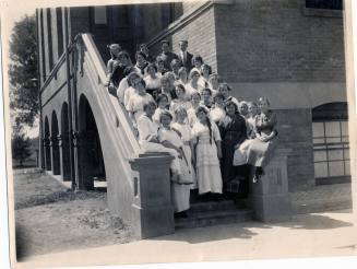 Class on Stairs of Campus Building