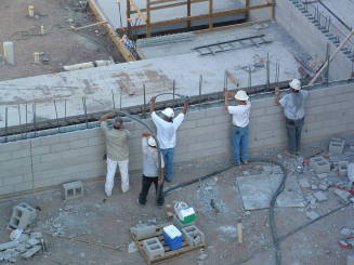 Tempe Center for the Arts construction photograph-Workers Filling Cinderblock Wall with Concrete