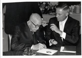 Senator Carl Hayden and another man sign a document