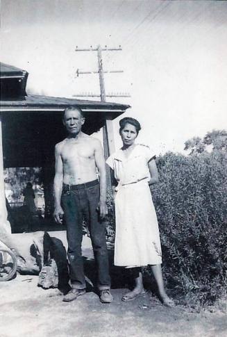 Vincent and Irene Rodriguez standing by Elias Rodriguez' Home Patio