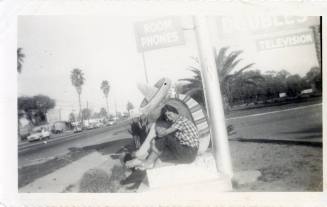 Marcie Rodriguez at Van Buren motel sign, Phoenix