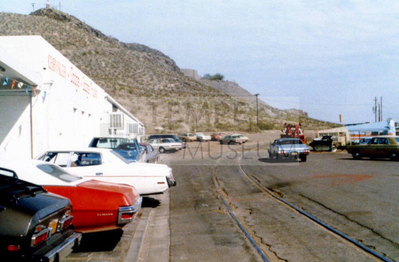 Dana Bros and train tracks on East 3rd Street. Hayden Butte in background.