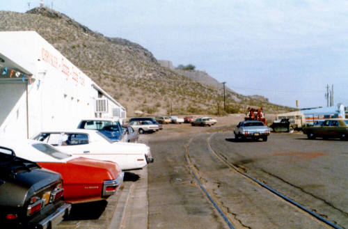 Dana Bros and train tracks on East 3rd Street. Hayden Butte in background.